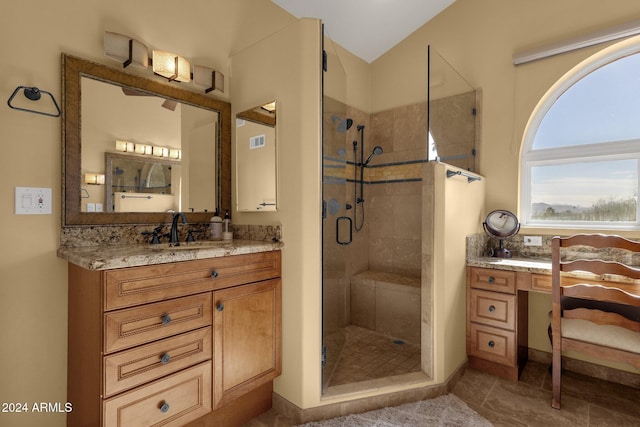 bathroom with vanity, tile patterned floors, walk in shower, and lofted ceiling