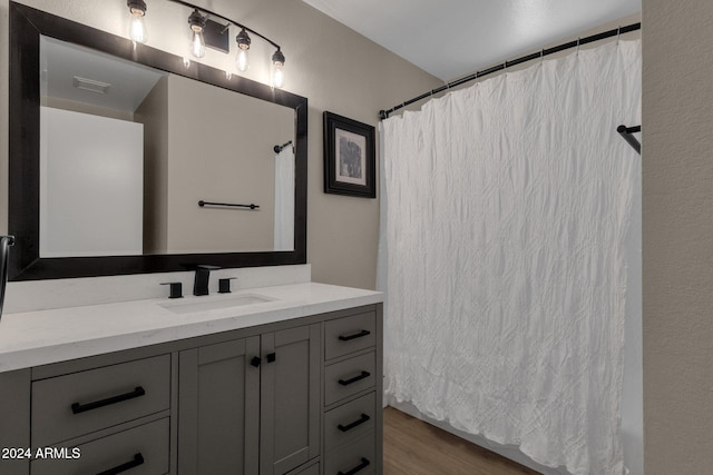 bathroom with vanity, hardwood / wood-style floors, and curtained shower