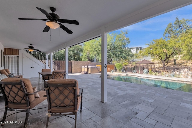 view of patio / terrace with ceiling fan and a fenced in pool