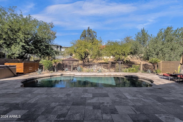 view of swimming pool with a gazebo and a patio area