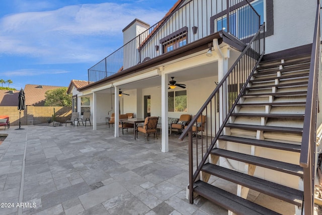 exterior space featuring ceiling fan and a balcony