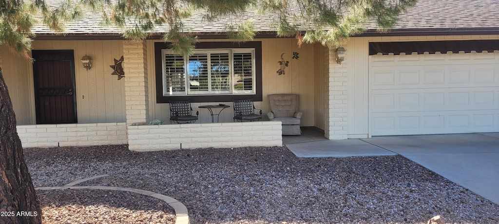 entrance to property with a garage and a porch