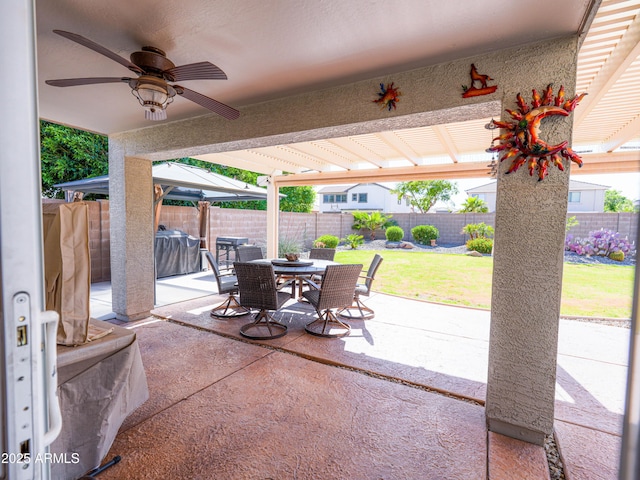 view of patio with a ceiling fan, outdoor dining space, and a fenced backyard
