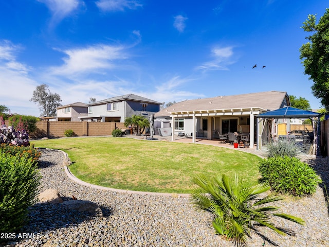 back of house featuring a gazebo, a yard, a patio, and a fenced backyard