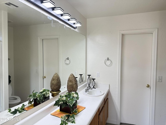 bathroom with toilet and vanity