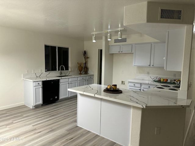 kitchen with dishwasher, kitchen peninsula, sink, white cabinetry, and light stone countertops