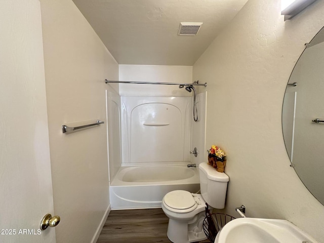 full bathroom with sink, wood-type flooring, toilet, and bathing tub / shower combination