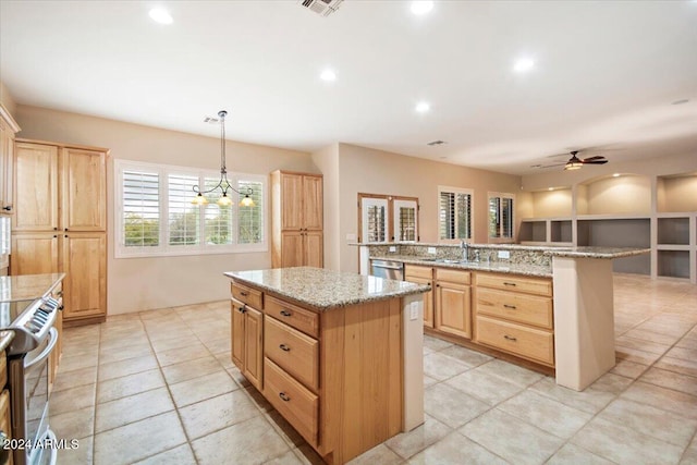 14428 E Monument Dr, Scottsdale, AZ 85262 - kitchen with visible vents, a center island, light stone counters, appliances with stainless steel finishes, and hanging light fixtures