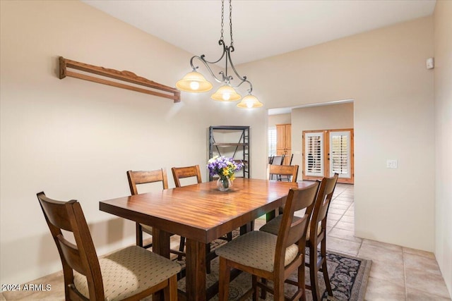 dining area featuring french doors and light tile patterned floors