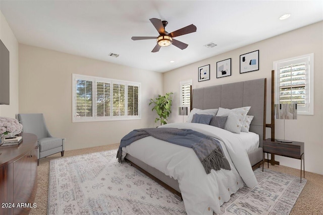 bedroom featuring light carpet and ceiling fan