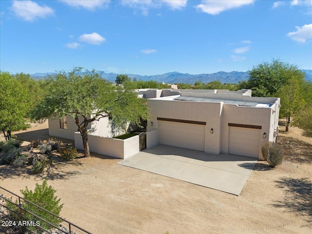 14428 E Monument Dr, Scottsdale, AZ 85262 - southwest-style home featuring a garage, fence, stucco siding, concrete driveway, and a mountain view