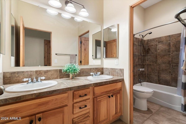 full bathroom with vanity, shower / bath combo with shower curtain, toilet, and tile patterned flooring