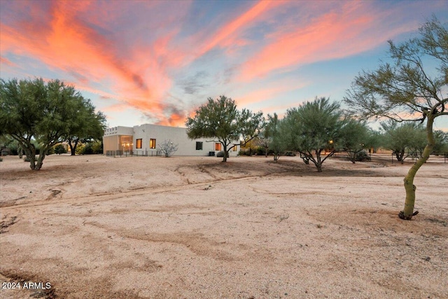 14428 E Monument Dr, Scottsdale, AZ 85262 - property exterior at dusk featuring central air condition unit, fence, and stucco siding