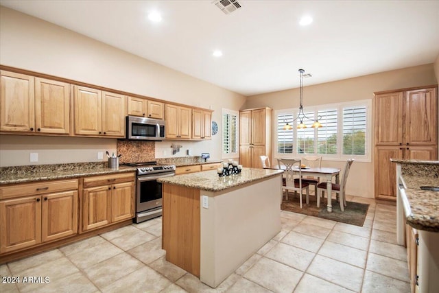 kitchen with hanging light fixtures, light stone counters, an inviting chandelier, stainless steel appliances, and a center island