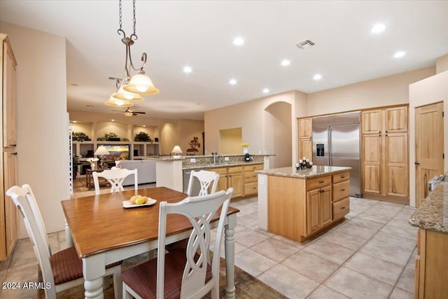 14428 E Monument Dr, Scottsdale, AZ 85262 - kitchen featuring light stone countertops, ceiling fan, a center island, a sink, and stainless steel appliances