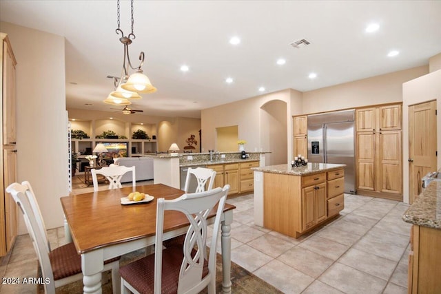 dining area featuring sink, ceiling fan, built in features, and light tile patterned flooring