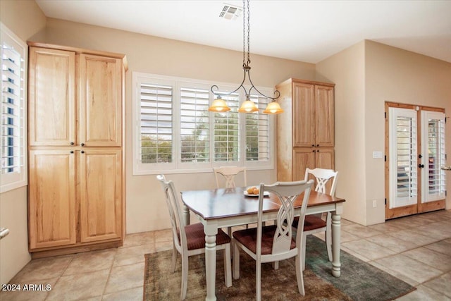 dining area featuring a chandelier and light tile patterned floors