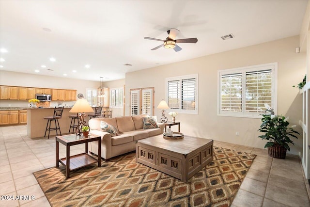 living room featuring light tile patterned floors and ceiling fan