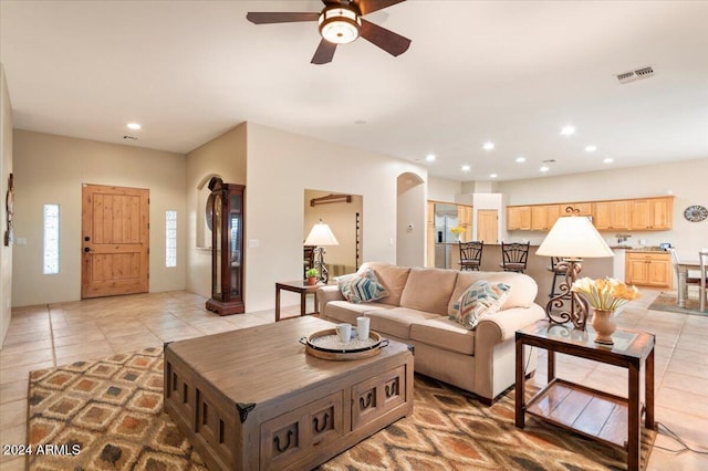 14428 E Monument Dr, Scottsdale, AZ 85262 - living room with arched walkways, ceiling fan, built in features, and light tile patterned floors
