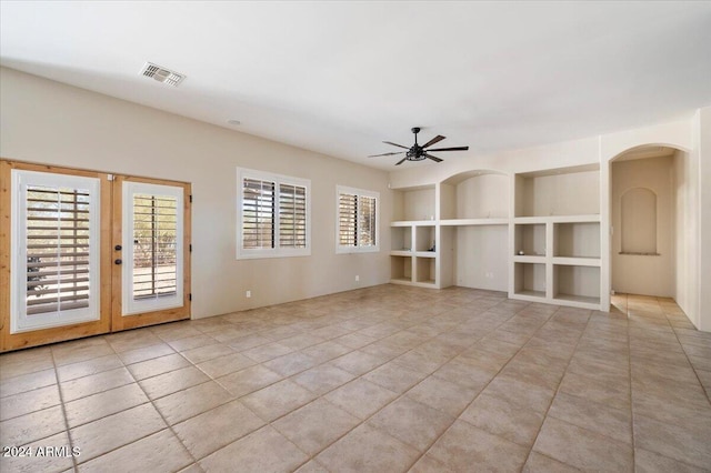 spare room featuring french doors, ceiling fan, and light tile patterned floors