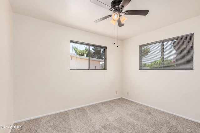 spare room with carpet, baseboards, and ceiling fan