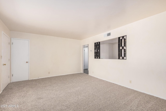 empty room with carpet floors and baseboards