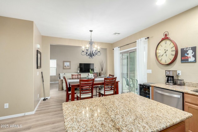 kitchen featuring beverage cooler, visible vents, stainless steel dishwasher, light wood-style flooring, and a notable chandelier