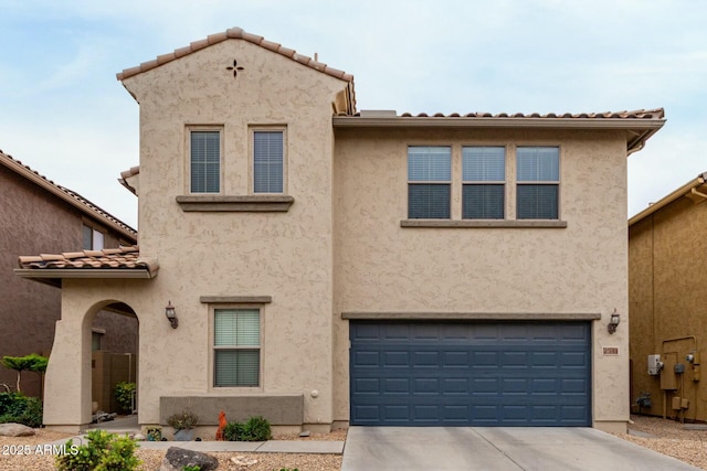 view of front of property with an attached garage, driveway, and stucco siding