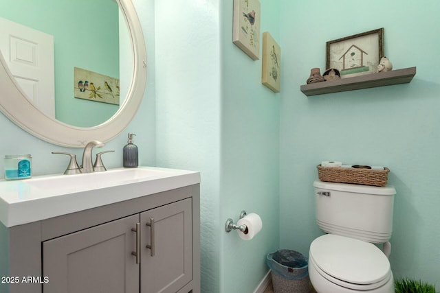 half bathroom with toilet and vanity
