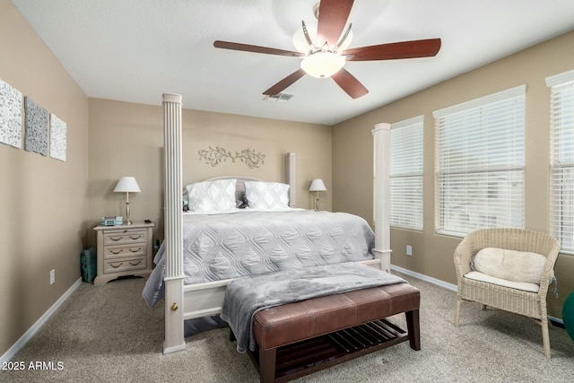 carpeted bedroom with visible vents, a ceiling fan, and baseboards