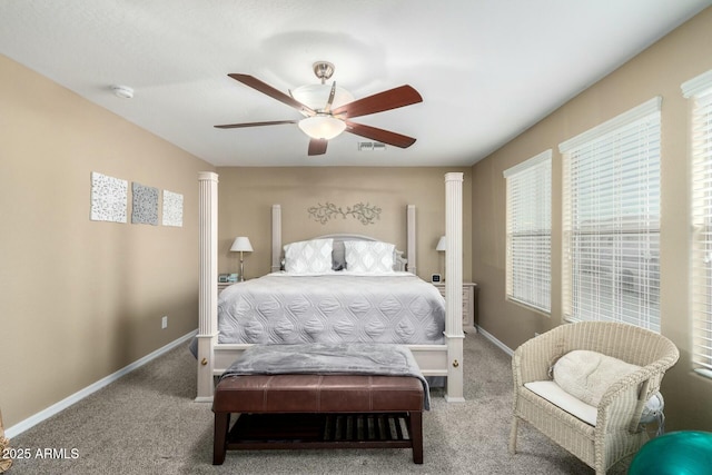 carpeted bedroom with visible vents, baseboards, and multiple windows