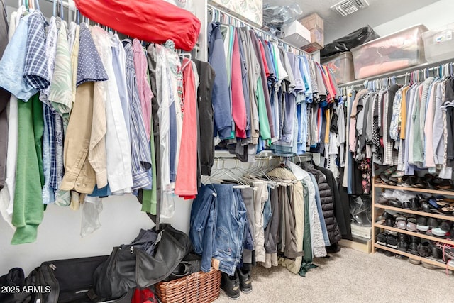 walk in closet with visible vents and carpet floors