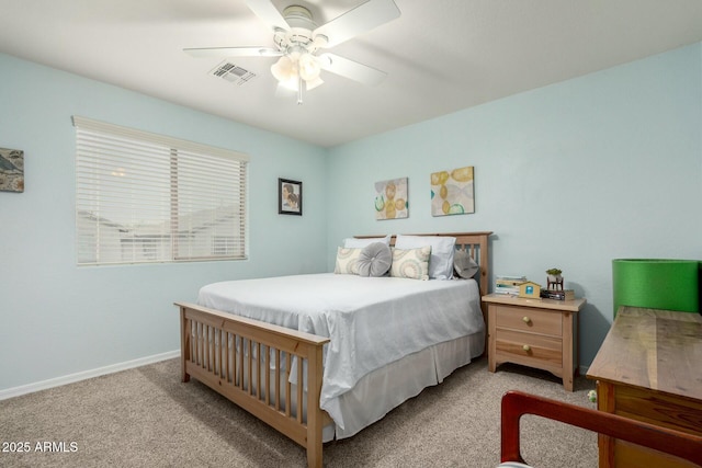 carpeted bedroom featuring baseboards, a ceiling fan, and visible vents