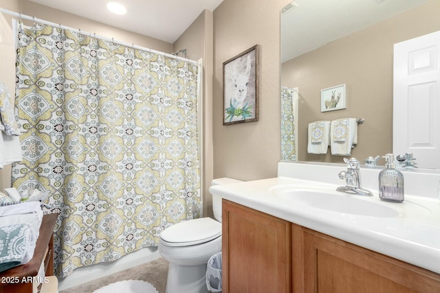 bathroom featuring vanity and toilet