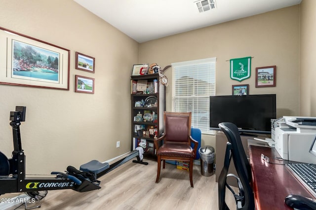 office space with wood finished floors and visible vents