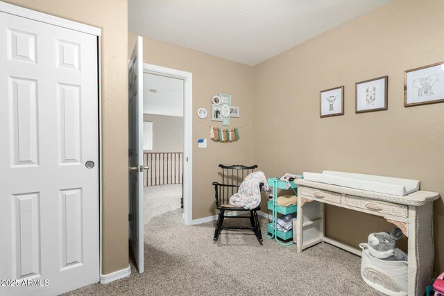 carpeted office space featuring baseboards