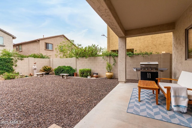 view of patio with a fenced backyard and a grill