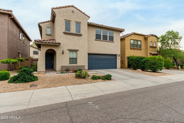 mediterranean / spanish house featuring a tile roof, driveway, an attached garage, fence, and stucco siding