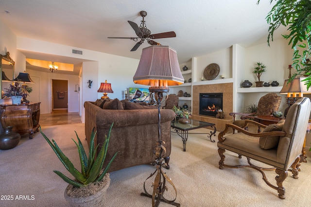 19700 N 76th St Unit 2001, Scottsdale, AZ 85255 - carpeted living room featuring a fireplace, built in shelves, ceiling fan, and visible vents