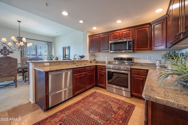 19700 N 76th St Unit 2001, Scottsdale, AZ 85255 - kitchen with a notable chandelier, a sink, appliances with stainless steel finishes, a peninsula, and recessed lighting
