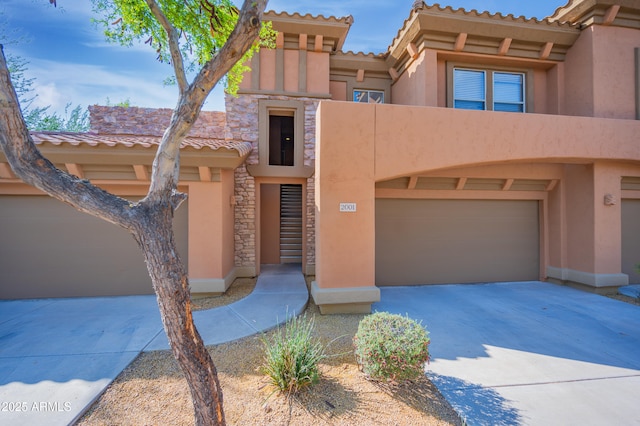 19700 N 76th St Unit 2001, Scottsdale, AZ 85255 - view of front facade with a tile roof, driveway, stone siding, stucco siding, and an attached garage