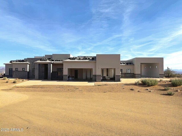 adobe home featuring stucco siding