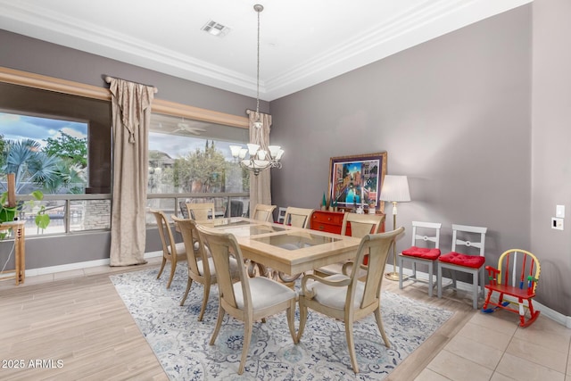 dining area with visible vents, baseboards, a notable chandelier, and light wood-style flooring