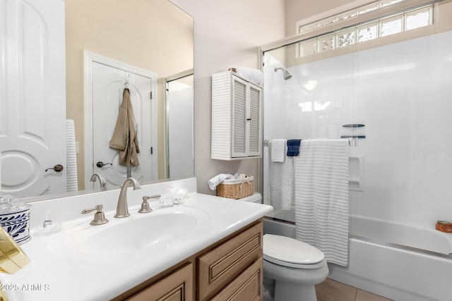 full bath with tile patterned floors, combined bath / shower with glass door, toilet, and vanity