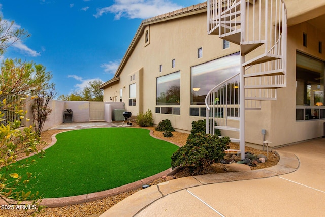 view of yard with a patio, cooling unit, and fence