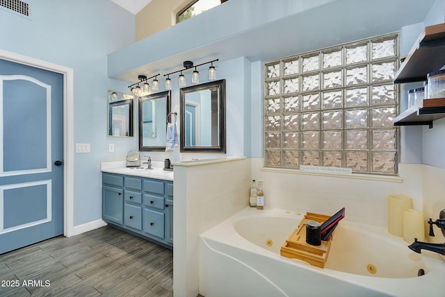 10226 W Country Club Trl, Peoria, AZ 85383 - bathroom featuring vanity, a whirlpool tub, and wood finished floors