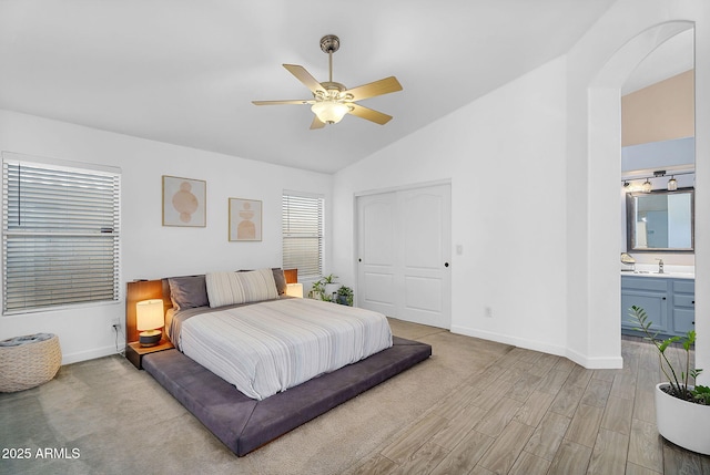 10226 W Country Club Trl, Peoria, AZ 85383 - bedroom featuring baseboards, lofted ceiling, light wood finished floors, a closet, and a sink