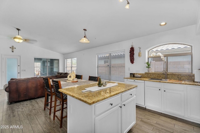 10226 W Country Club Trl, Peoria, AZ 85383 - kitchen featuring a sink, lofted ceiling, open floor plan, light wood finished floors, and white cabinets