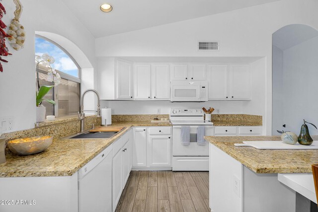 10226 W Country Club Trl, Peoria, AZ 85383 - kitchen with white appliances, a sink, vaulted ceiling, white cabinets, and light wood-type flooring