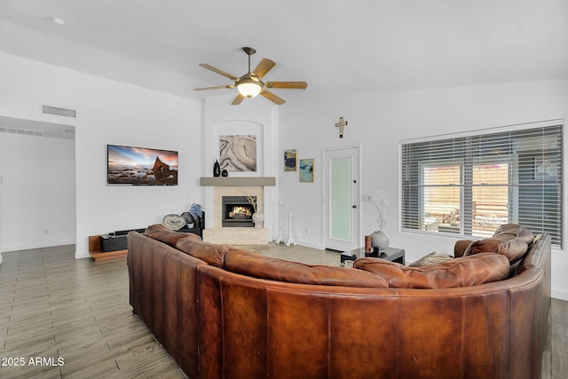 10226 W Country Club Trl, Peoria, AZ 85383 - living room featuring ceiling fan, a fireplace, and baseboards